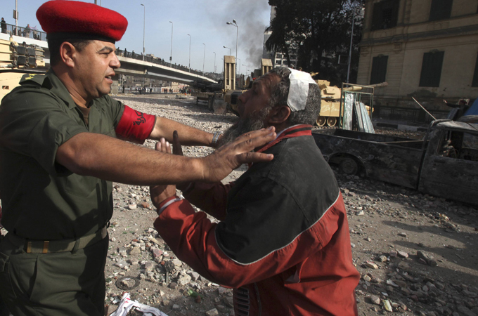 Policeman restraining injured man
