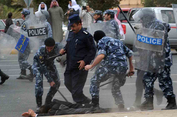 Kuwait police arresting demonstrator