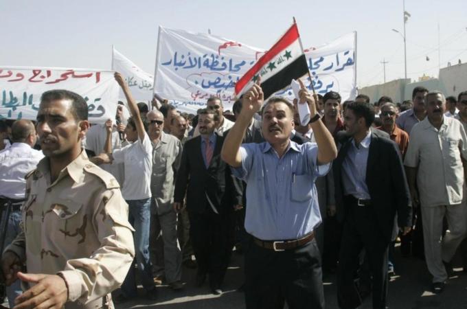 Residents chant slogans during a protest about the auctioning of Akkas gas field in Ramadi