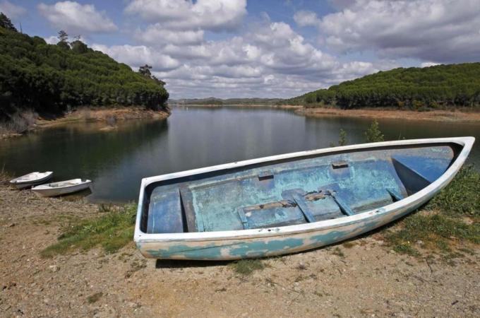 Boat is seen out of water during a draught on the dam reservoir of Santa Clara a Velha in Southern Portugal