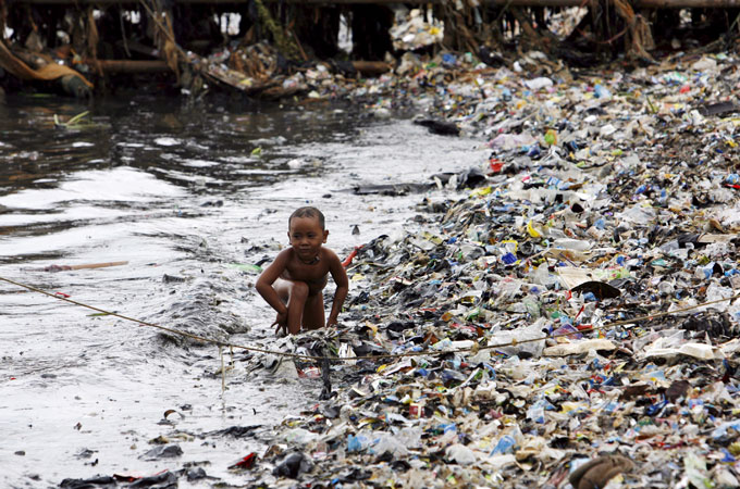 boy on garbage beach