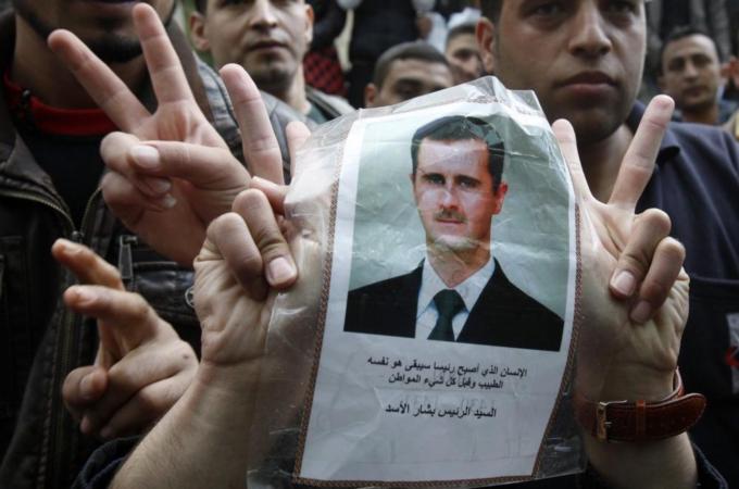 Syrian university students in Lebanon, flash victory signs as they carry a picture of Syria''s President Bashar al-Assad during a demonstration in front of the Syrian embassy in Beirut
