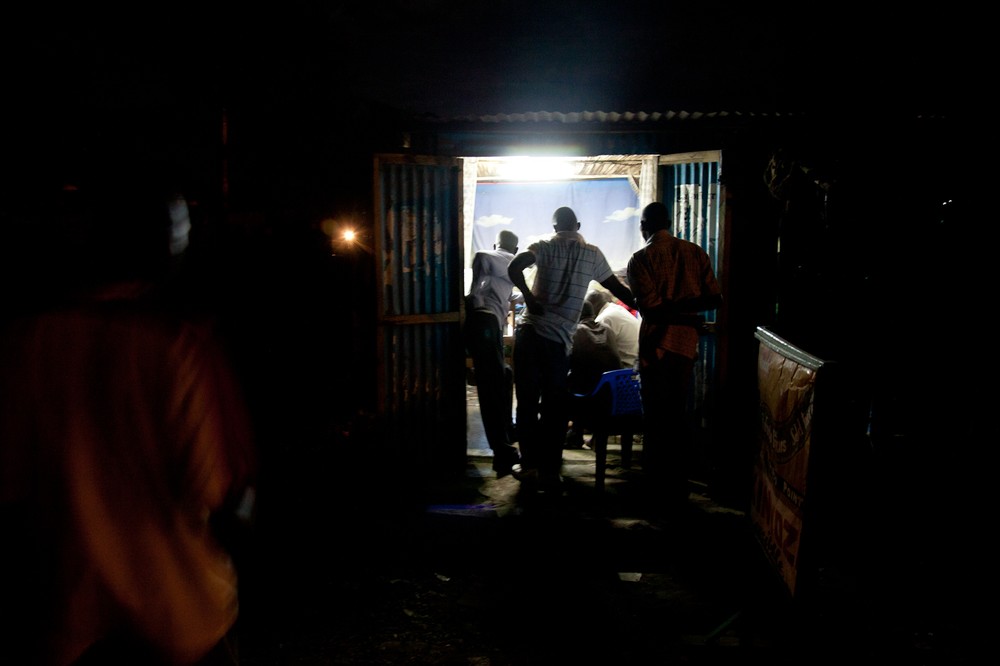 Kisumu residents watch the presidential debate in a barbershop. Kenya(***)s third largest city, the stronghold of candidate Raila Odinga, erupted in violence after it was announced Odinga had lost the 2007 vote.