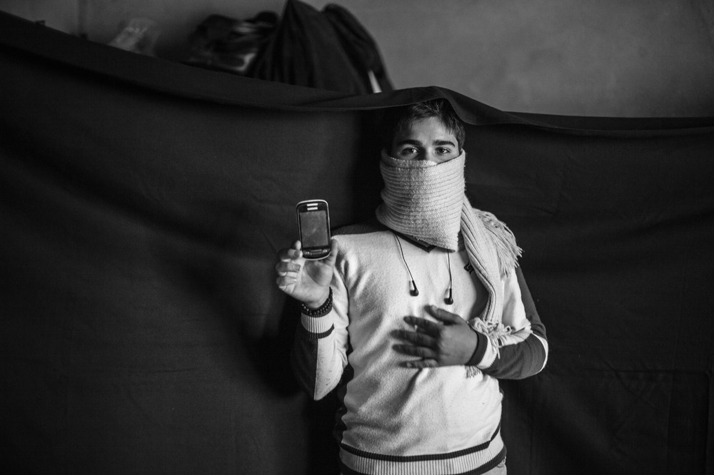 Yusuf and his family fled their home several months before this photograph was taken. The most important thing he was able to bring from Syria is the mobile phone that he holds in this photograph. "With this, I(***)m able to call my father. We(***)re close enough to Syria here that I can catch signal from the Syrian towers sometimes." The phone also holds photographs of family members who are still in Syria, which he is able to keep with him at all times.