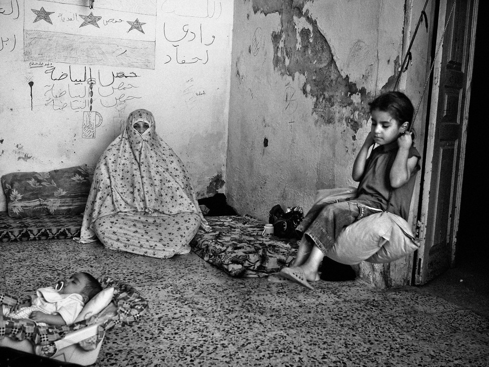 Nine-year-old Rania, right, sits on a swing inside her extended family(***)s home in East Amman, an area where many Syrian refugees have rented apartments. Her father and all the men in the family are still in Syria.