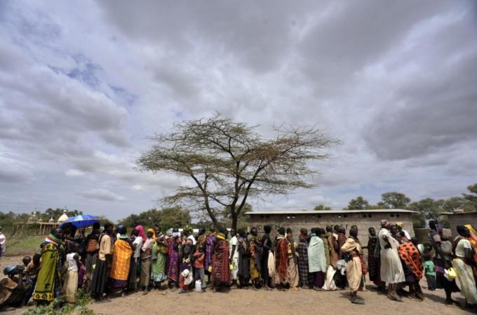 Turkana women and children wait for supp