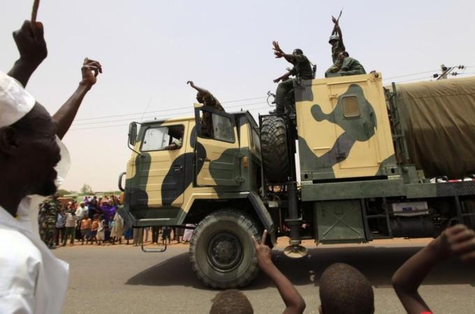Al-Rahaad residents celebrate as a military convoy returns from Abu Kershola, at Al- Rahaad in North Kordofan State