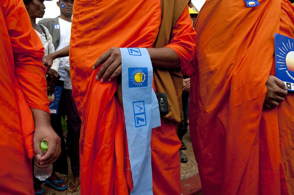 Buddhist monks hold political material in support of the CNRP.