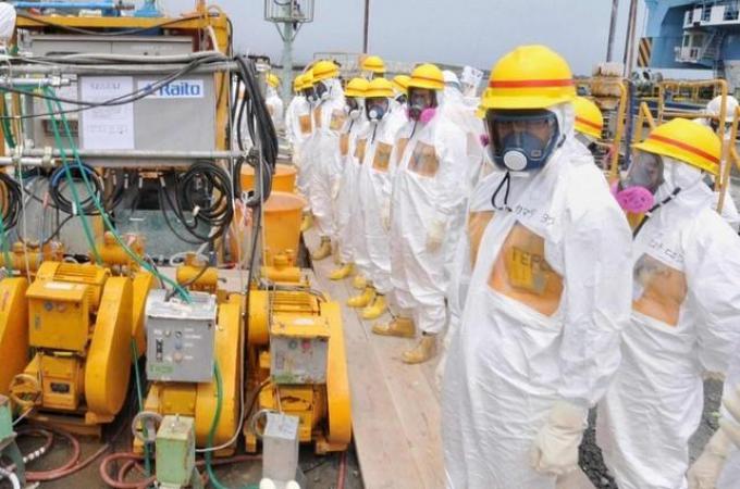 Members of a Fukushima prefecture panel inspect the construction site of a shore barrier near the No.1 and No.2 reactor building of the tsunami-crippled Fukushima Daiichi nuclear power plant
