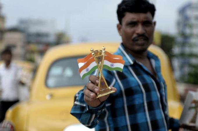 An Indian street vendor poses with India