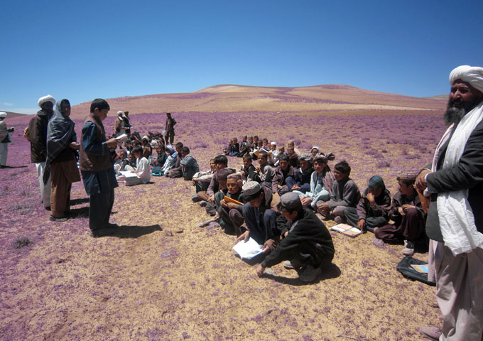 Children sit on ground