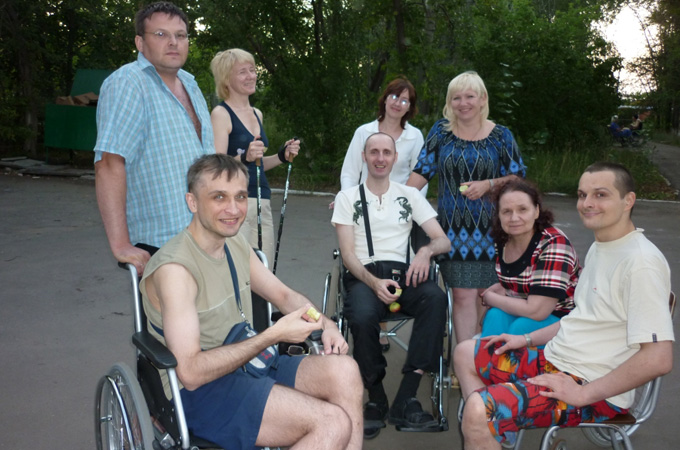 Pavel, left, uses a wheelchair to move around and delegates tasks such as cooking and cleaning to family members [Al Jazeera]