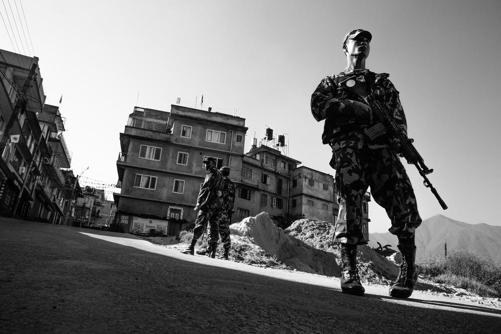 Nepali soldiers prevent people from entering a street where a bomb was found outside of a polling station during Nepalese Constituent Assembly elections in Kirtipur.