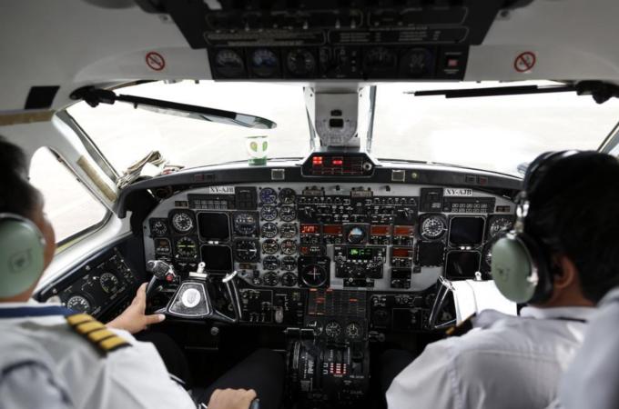Many professionals, like airplane pilots, are now required to speak English by industry standards [Reuters]