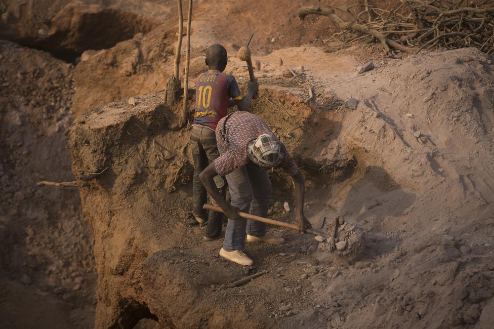 <p>Two young boys dig pits at an artisanal gold mining site in southern Mali. Their fathers also work at the mines. Many parents encourage their children to work in order to contribute to household finances. </p>