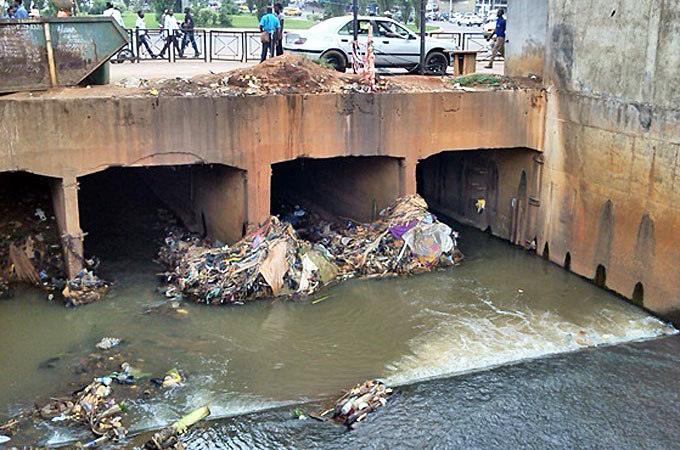 Plastic waste piles up under a bridge in the capital of Cameroon, Yaounde [Eugene Nforngwa/Al Jazeera]