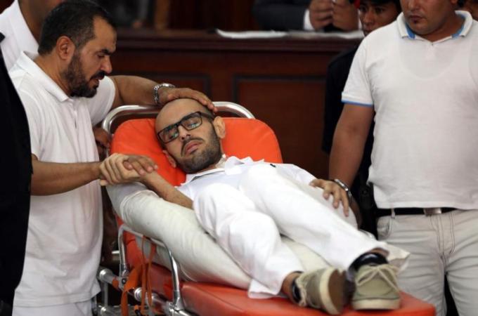Mohammed Soltan in court hall before the trial that accuses him with 'misinforming the media' [AFP]