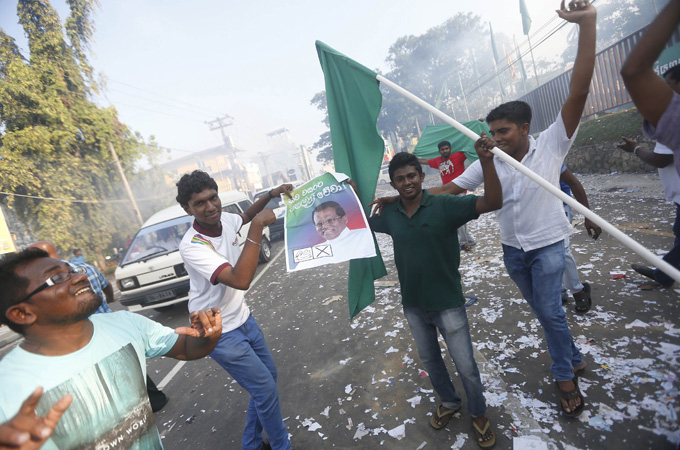 Supporters of presidential candidate Maithripala Sirisena celebrate in Colombo [Reuters]