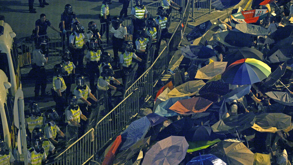 Student leaders Joshua Wong, Alex Chow, and Lester Shum take the stage on October 4, 2014 [Lee Xian Jie / Al Jazeera]