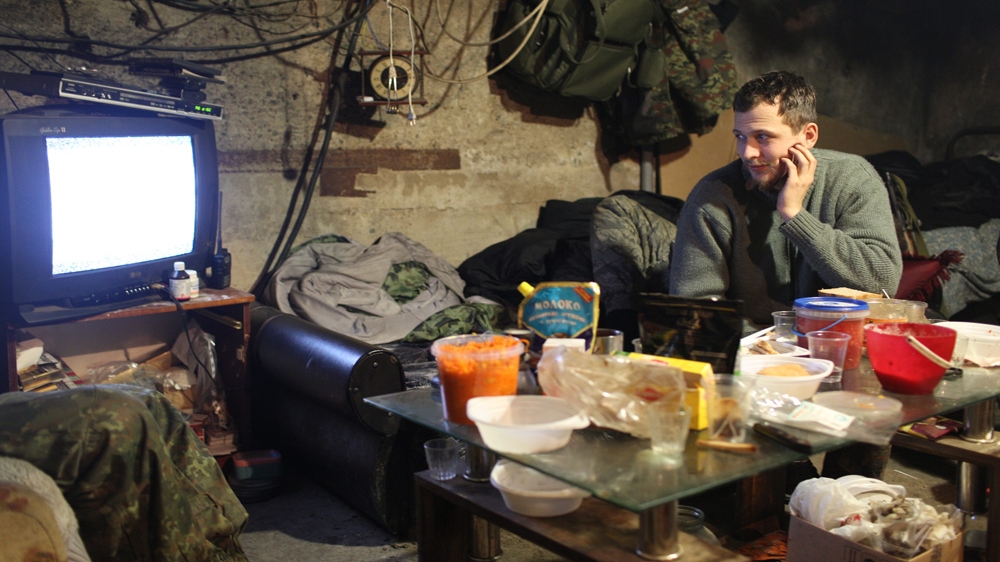 A member of the Dnipro-1 Battalion watches pro-Russian rebel television [John Wendle] 