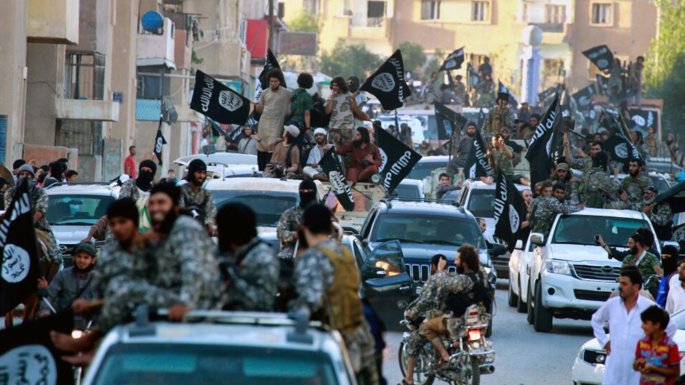 Fighters from the Islamic State of Iraq and the Levant [ISIL] group parade through Raqqa in June 2014 [ Raqqa Media Center of ISIL/AP ]