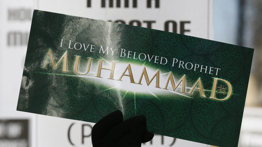 A Muslim demonstrator holds a placard during a protest against the publication of cartoons depicting the Prophet Mohammad in Charlie Hebdo, near Downing Street in central London