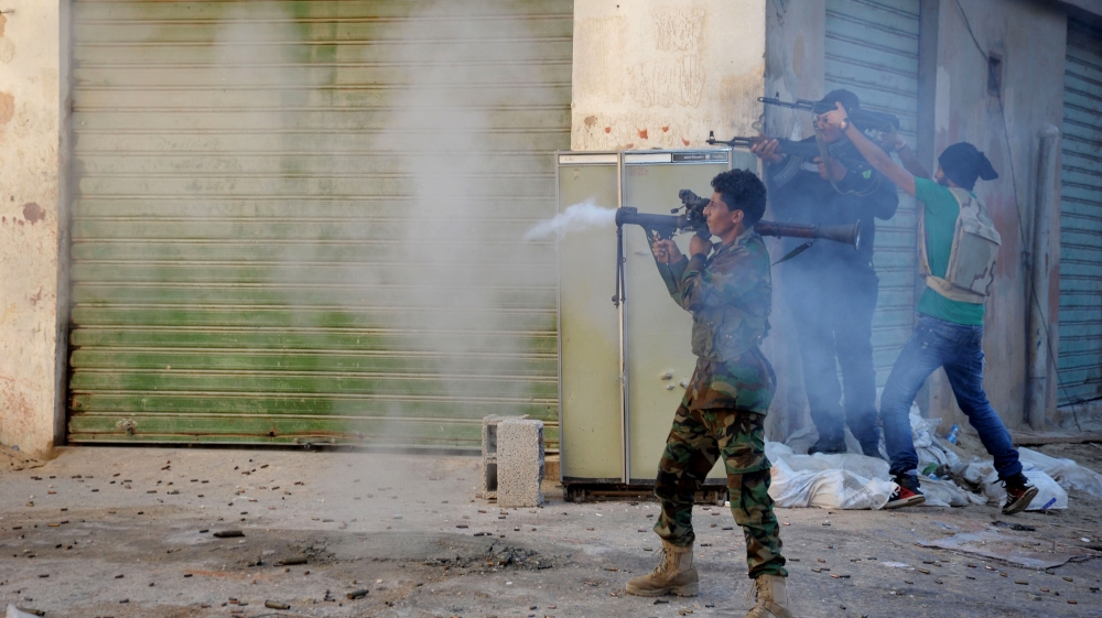 Libyan military soldiers fire their weapons during clashes with Islamic militias in Benghazi [AP]
