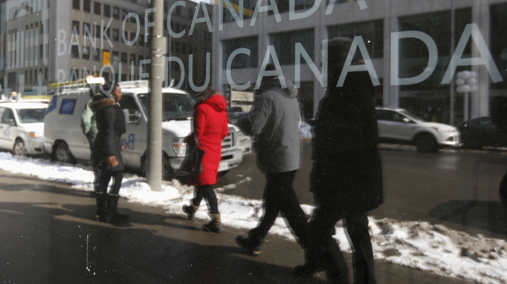 Pedestrians walk past the Bank of Canada office in Ottawa
