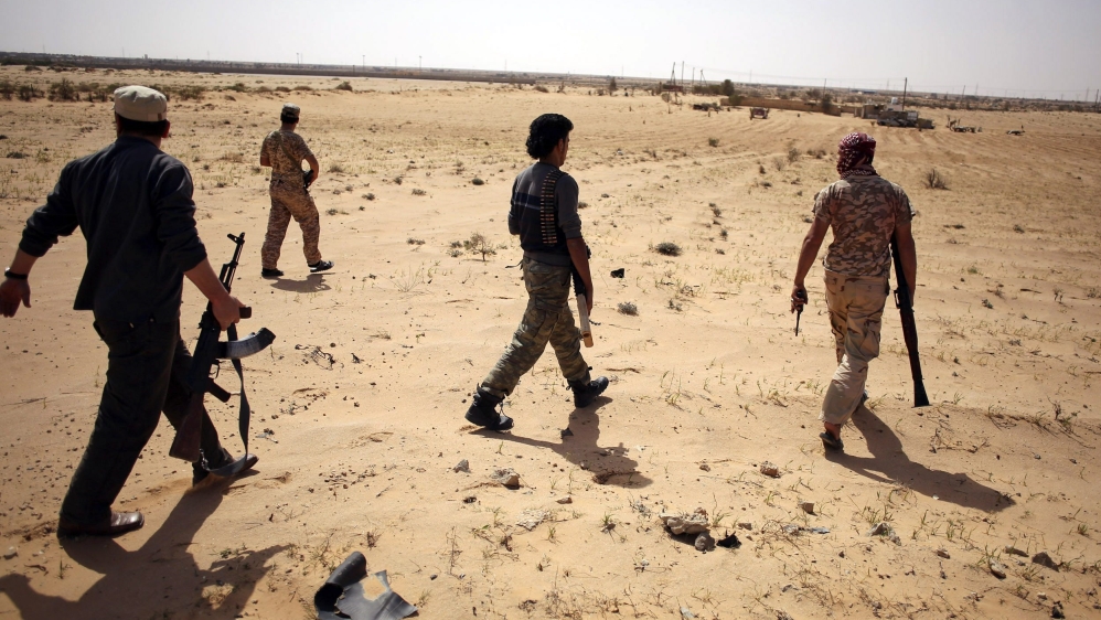 Libya Dawn fighters search for ISIL militants during a patrol near Sirte [Reuters]