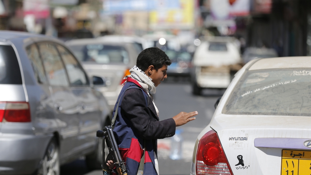 A Houthi fighter mans a checkpoint on a road leading to the Presidential Palace in Sanaa
