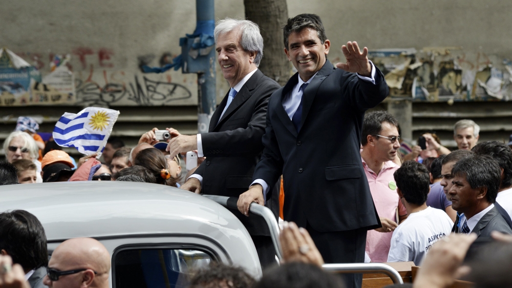 Tabare Vazquez and Raul Sendic wave to the crowd after Vazquez was sworn in as Uruguay''s new president in Montevideo