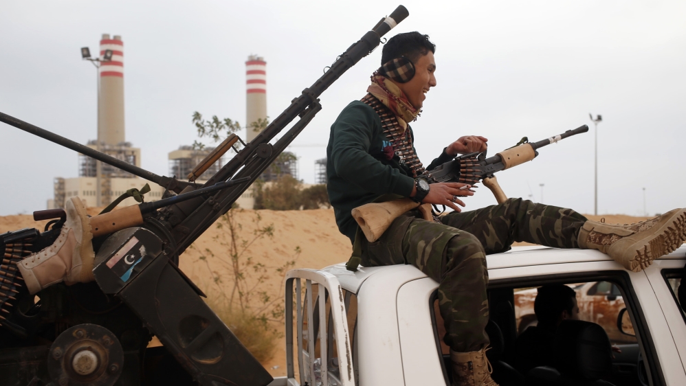 Fighter from Misrata sits on top of a vehicle near Sirte