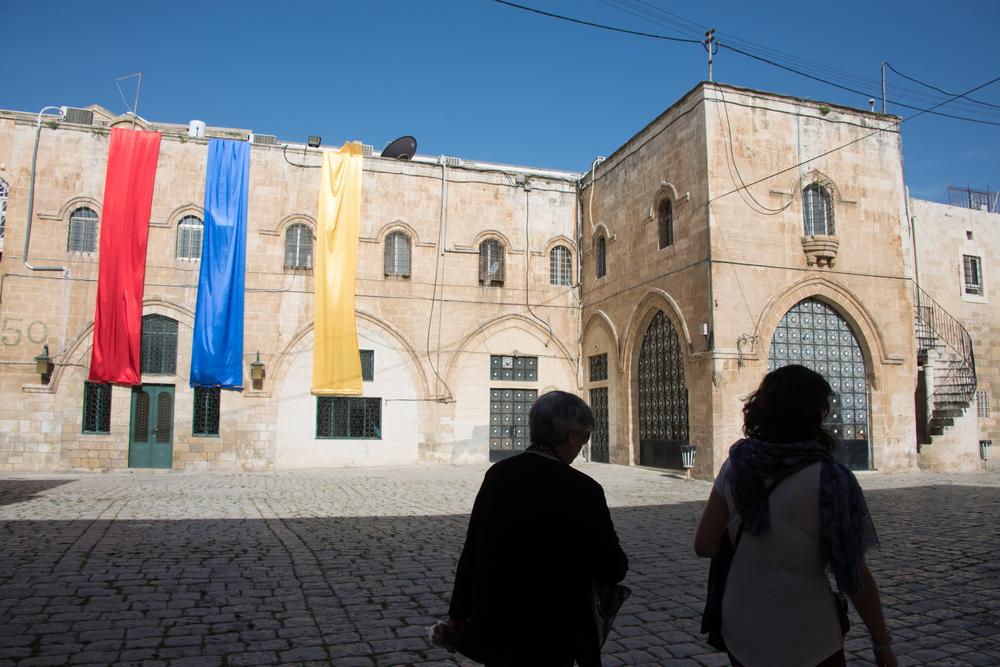 The convent that surrounds St James Cathedral remains off-limits to visitors without a local guide. Here, the colours of the Armenian flag hang overhead as members of the Armenian community cross the convent courtyard.