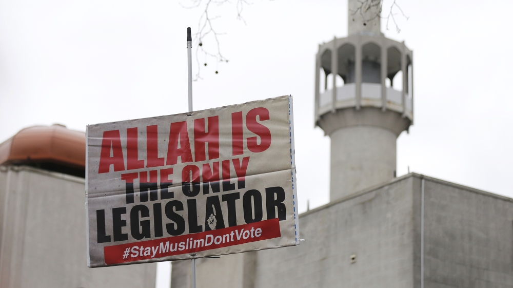 A banner calling for British Muslims not to vote as part of the Stay Muslim Don''t Vote campaign is held aloft outside the London Central Mosque in London [REUTERS]