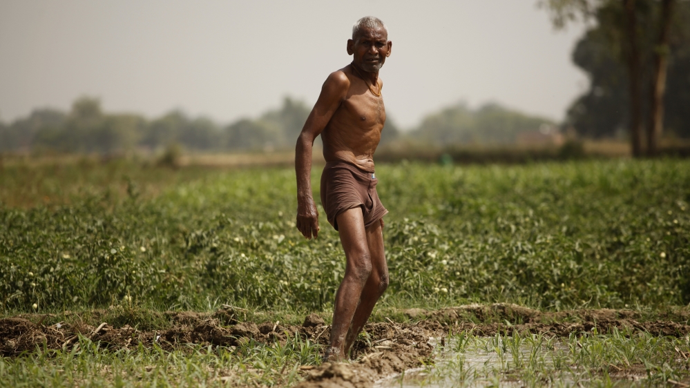 Indian farmer irrigates his field on the outskirts of Allahabad, India [AP]