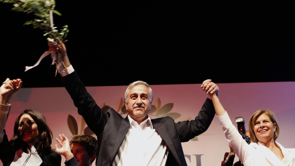 Turkish Cypriot newly elected leader Mustafa Akinci with his wife Miral wave to his supporters after he won the leadership election in the Turkish Cypriot breakaway north [AP]