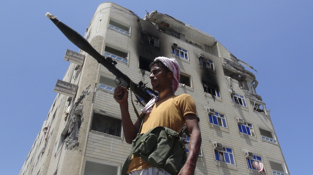 A Southern Popular Resistance fighter secures a street during fighting against Houthi fighters in the Dar Saad district of Yemen''s southern port city of Aden