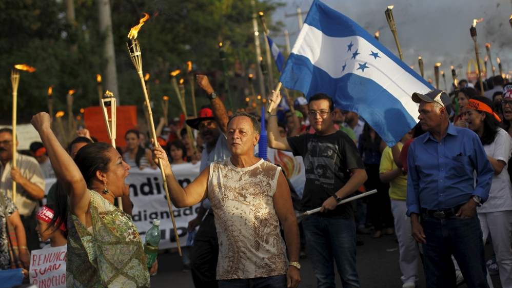 People take part in a march to demand the resignation of Honduras'' President Juan Hernandez in Tegucigalpa
