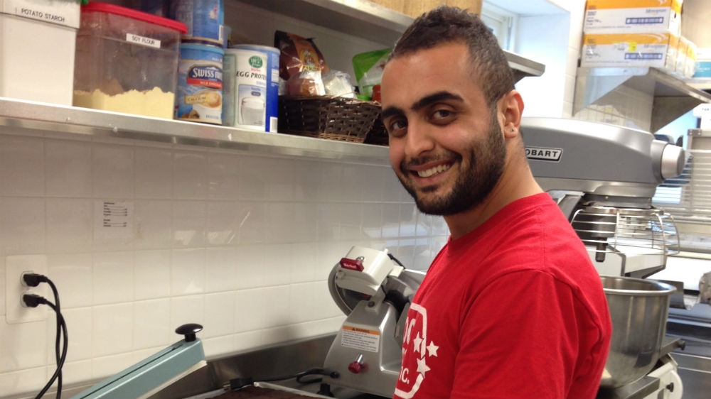 Iraqi citizen Sham Hassan, who worked as a translator during the Iraq war, works at the Dog Tag Bakery [Al Jazeera, Eric Taylor]