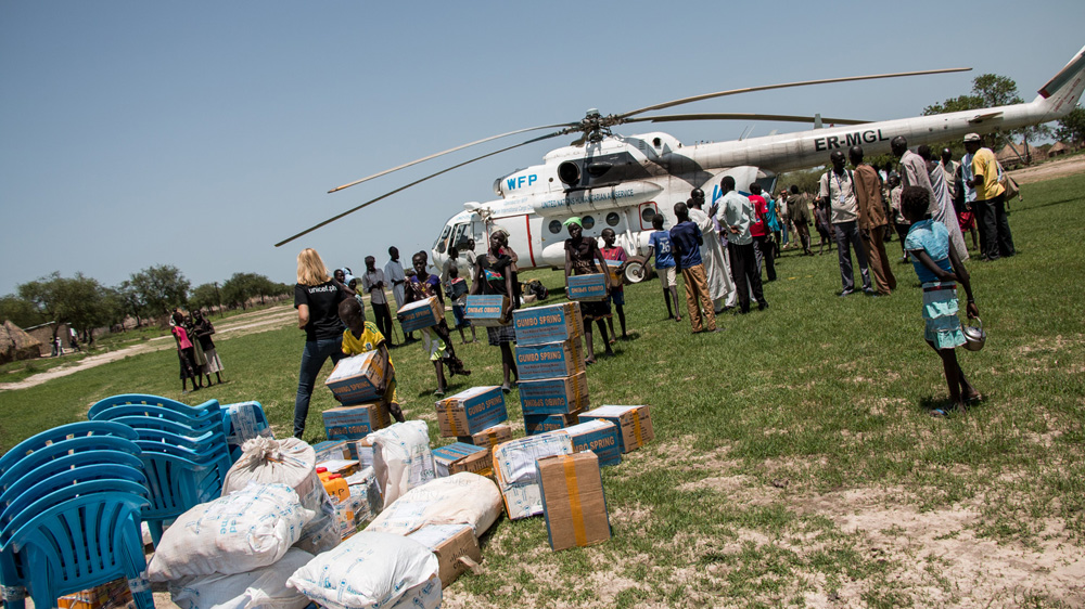 A crisis response team landed in the swamplands of Jonglei state by helicopter in order to provide up to 54,000 people with emergency aid [Ashley Hamer/Al Jazeera]