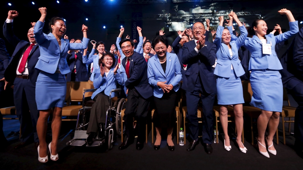 Members of the Beijing delegation celebrate after Beijing was awarded the 2022 Winter Olympic Games, defeating Almaty in the final round of voting, during the 128th IOC session in Kuala Lumpur