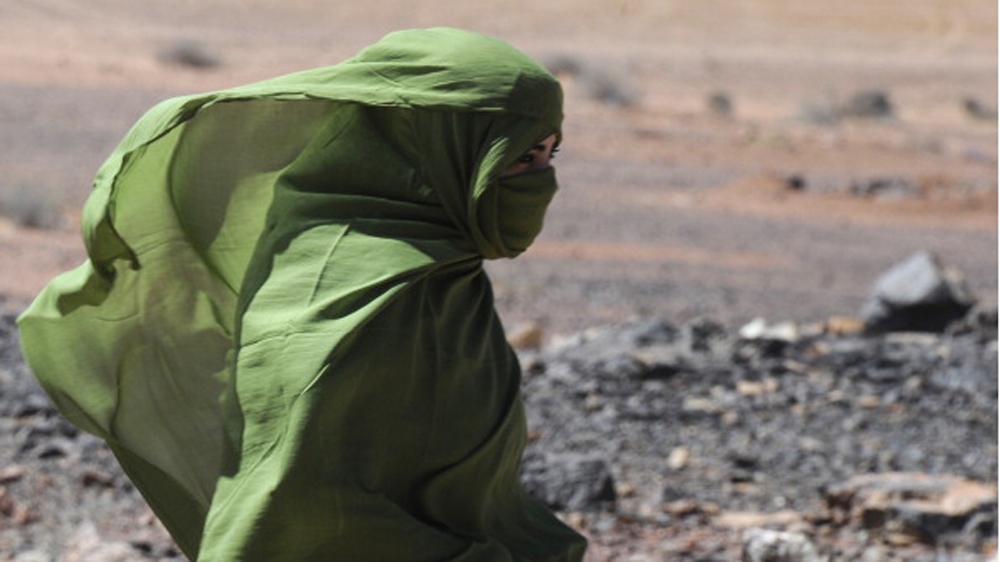 A Sahrawi woman walks in the desert near the Western Sahara village of Tifariti [AFP]