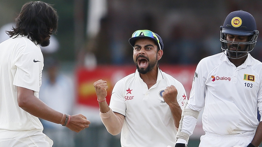 India''s Sharma celebrates with captain Kohli after taking the wicket of Sri Lanka''s Tharanga during the fourth day of their third and final test cricket match in Colombo