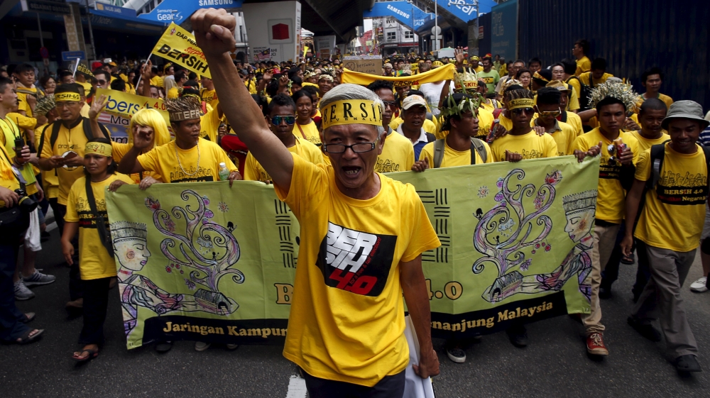 A supporter of pro-democracy group "Bersih" (Clean) leads a group of native people known as "orang asli", as they march to Dataran Merdeka in Malaysia''s capital city of Kuala Lumpur