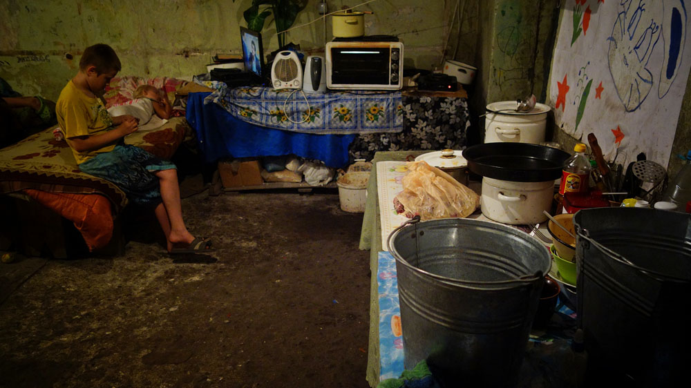 Civilians living in basements receive humanitarian aid and psychological support from NGOs [Filip Warwick/Al Jazeera]