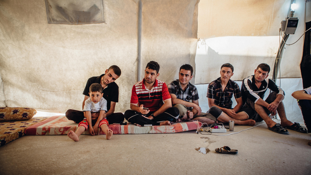 Eyad, second from left, a refugee from Sinjar who worked with a local smuggler to ensure the release of Noora from ISIL captivity [Andrea DiCenzo/Al Jazeera]