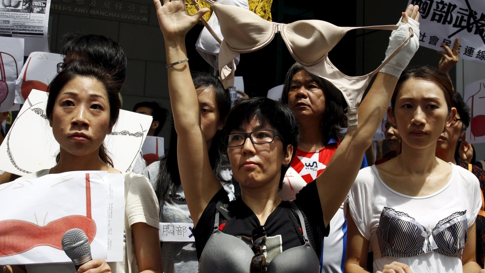 Protesters wear bras over their shirts during a demonstration in support of Hong Kong female protester Ng Lai-ying, outside the police headquarters in Hong Kong
