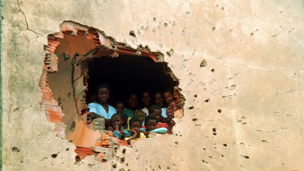 Locals take shelter during the fighting in Angola's long-running civil war. I was struck by how war-weary the women and children appeared. After the photograph was taken, they receded into the darkness. It bothered me that I never saw them again. 1993 [Jack Picone] 