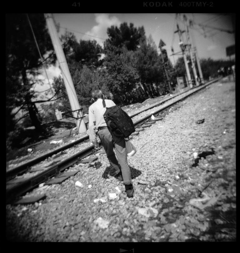 A Syrian refugee walks towards Greece's border with Macedonia, near the village of Idomeni – Idomeni, Greece, August 2015 [Giorgos Moutafis] 