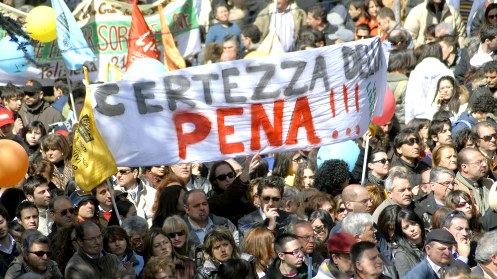 Calabrians hold banners and flags decrying organised crime during a 'Giornata della Memoria' [Adriana Sapone/AP]